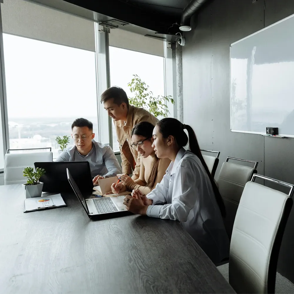 management team in an office working with computers